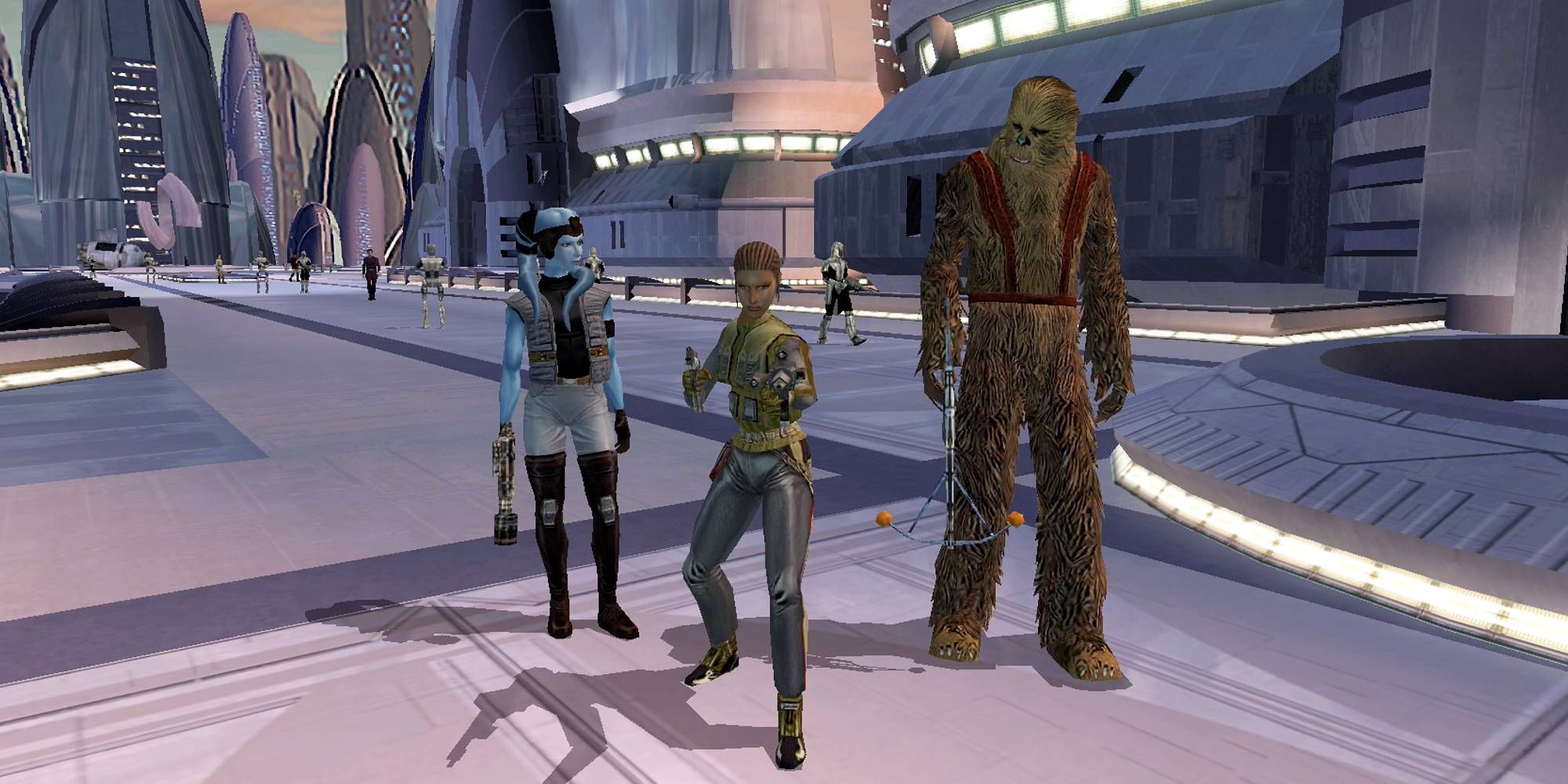A blue alien, a Wookie and a female figure stands in a sci-fi city in Star Wars Knights Of The Old Republic