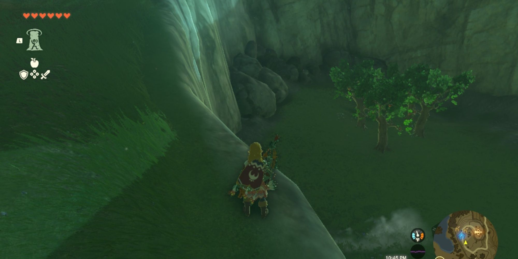 Link overlooking the entrance to the Wrestham Forest cave from Hateno's secret laboratory in The Legend of Zelda: Kingdom of Tears.
