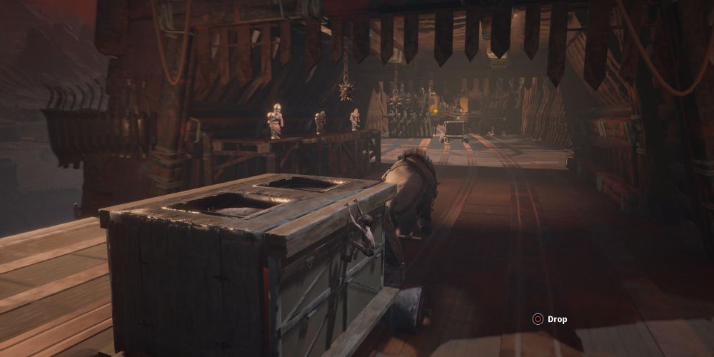 the lord of the rings: gollum hangs off the side of a cart to evade orc sentries