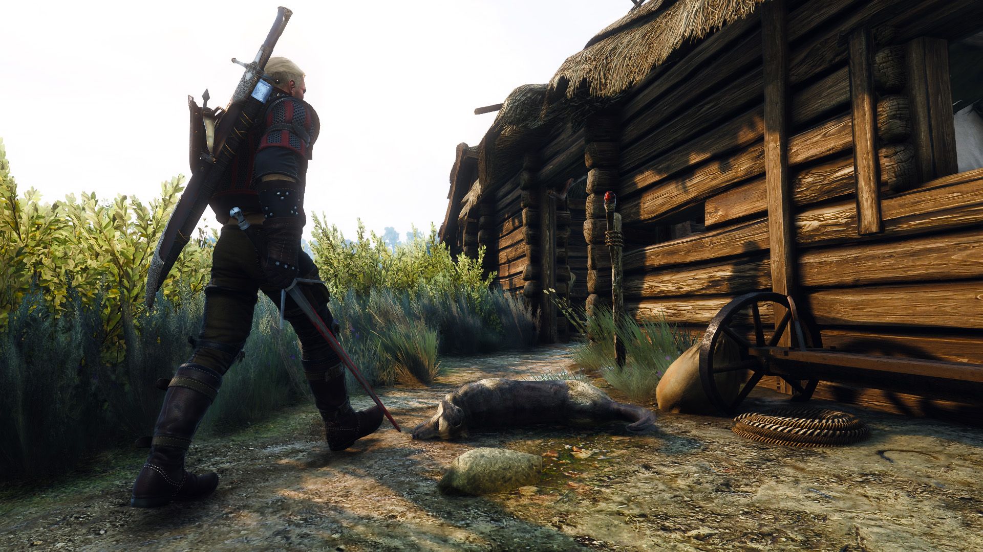 Geralt walks into a wooden shack with his silver sword drawn.