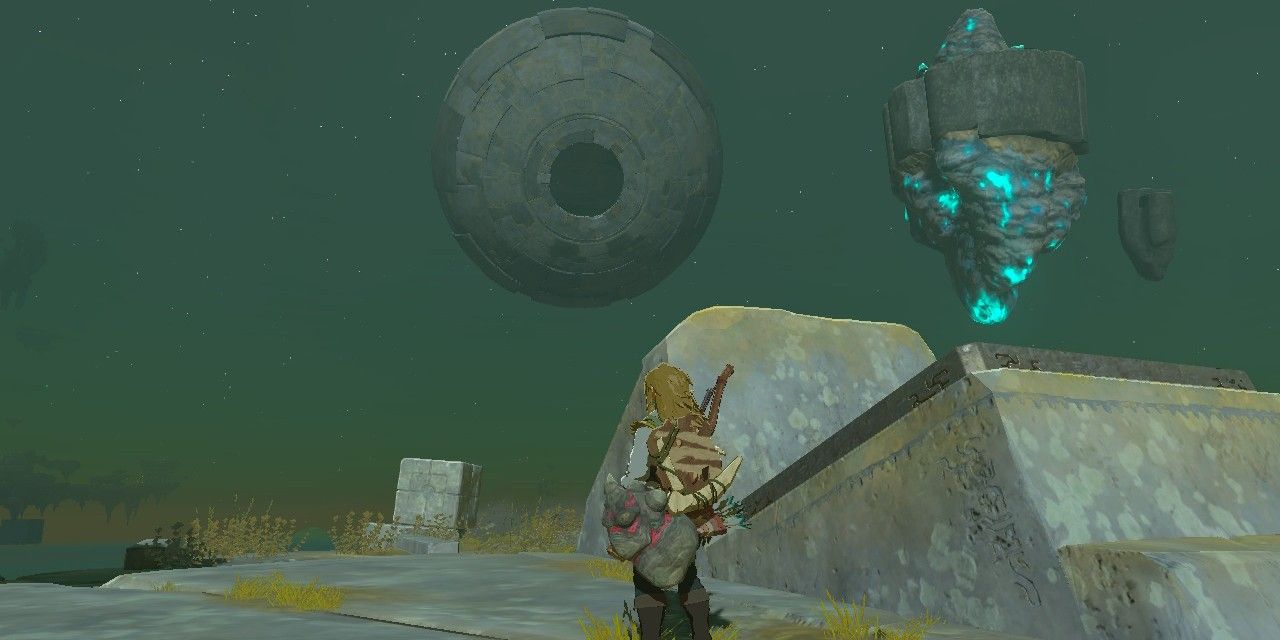 Screenshot of Zelda Tears of Kingdom of Link standing next to a launcher with a large orb in the background