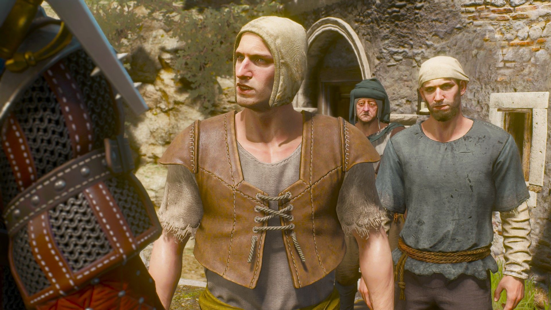 A pair of men square up against Geralt in a square in Toussaint.