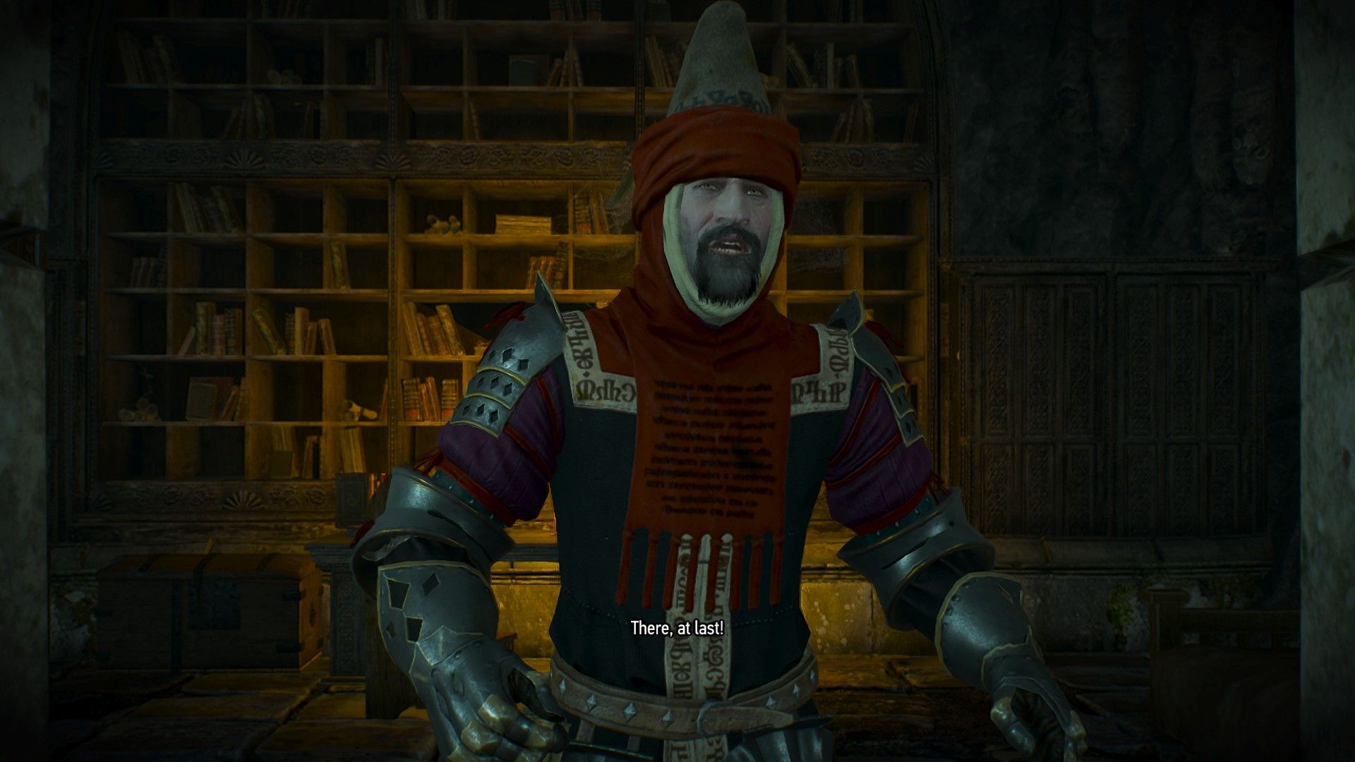A mage wearing red robes over his armor stumbles out of a library.