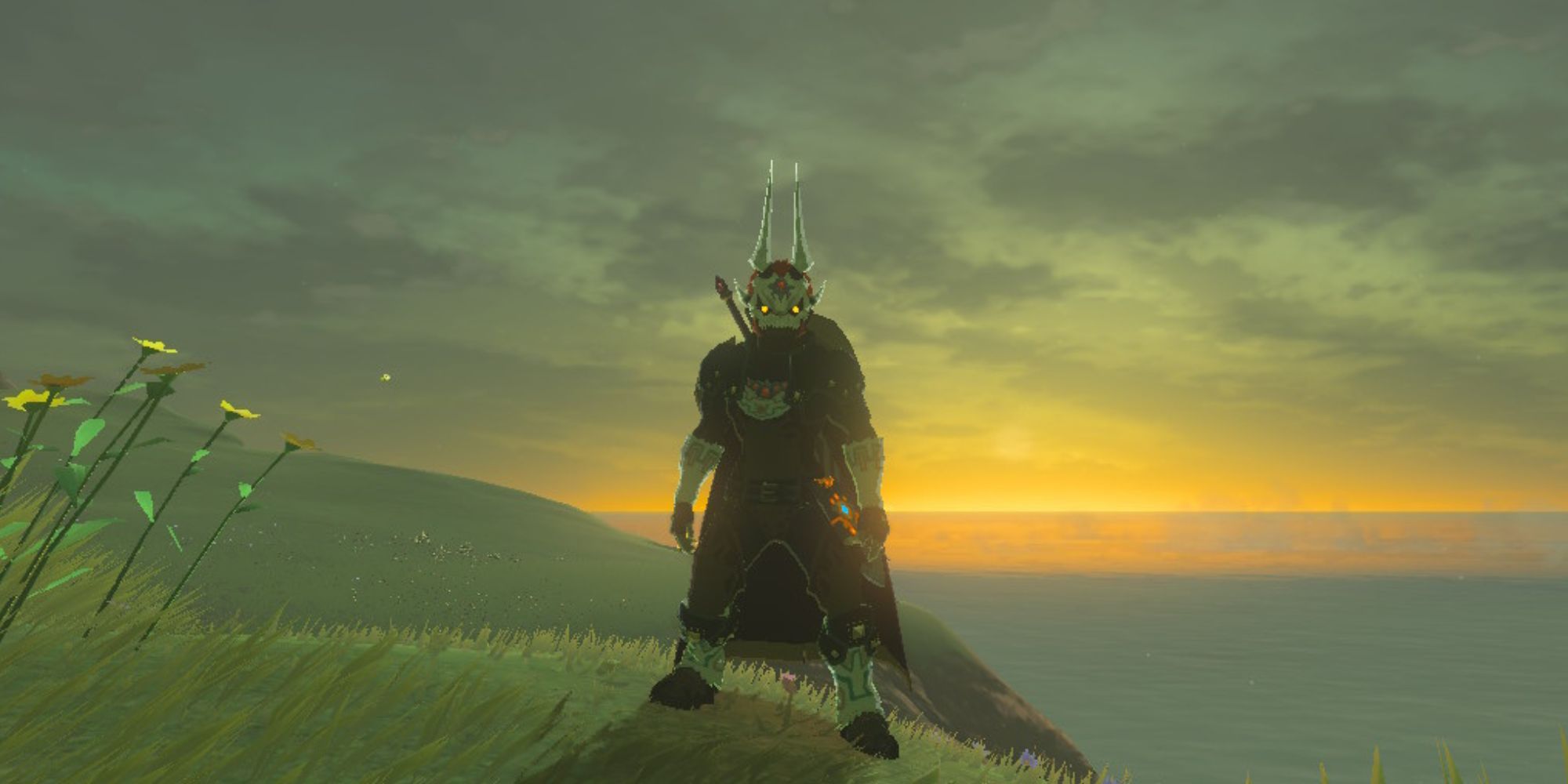 Link stands in front of a sunset while wearing the Phantom Ganon Set
