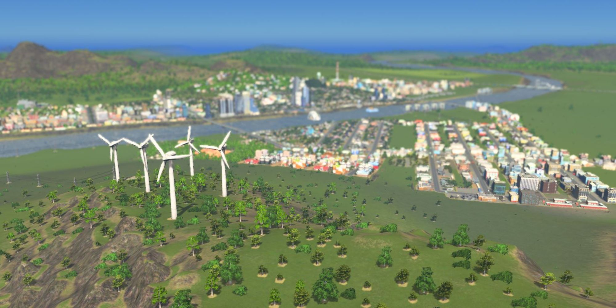 An image from Cities: Skylines of several wind turbines during the Green Power scenario, which requires you to power the city without using polluting industries.
