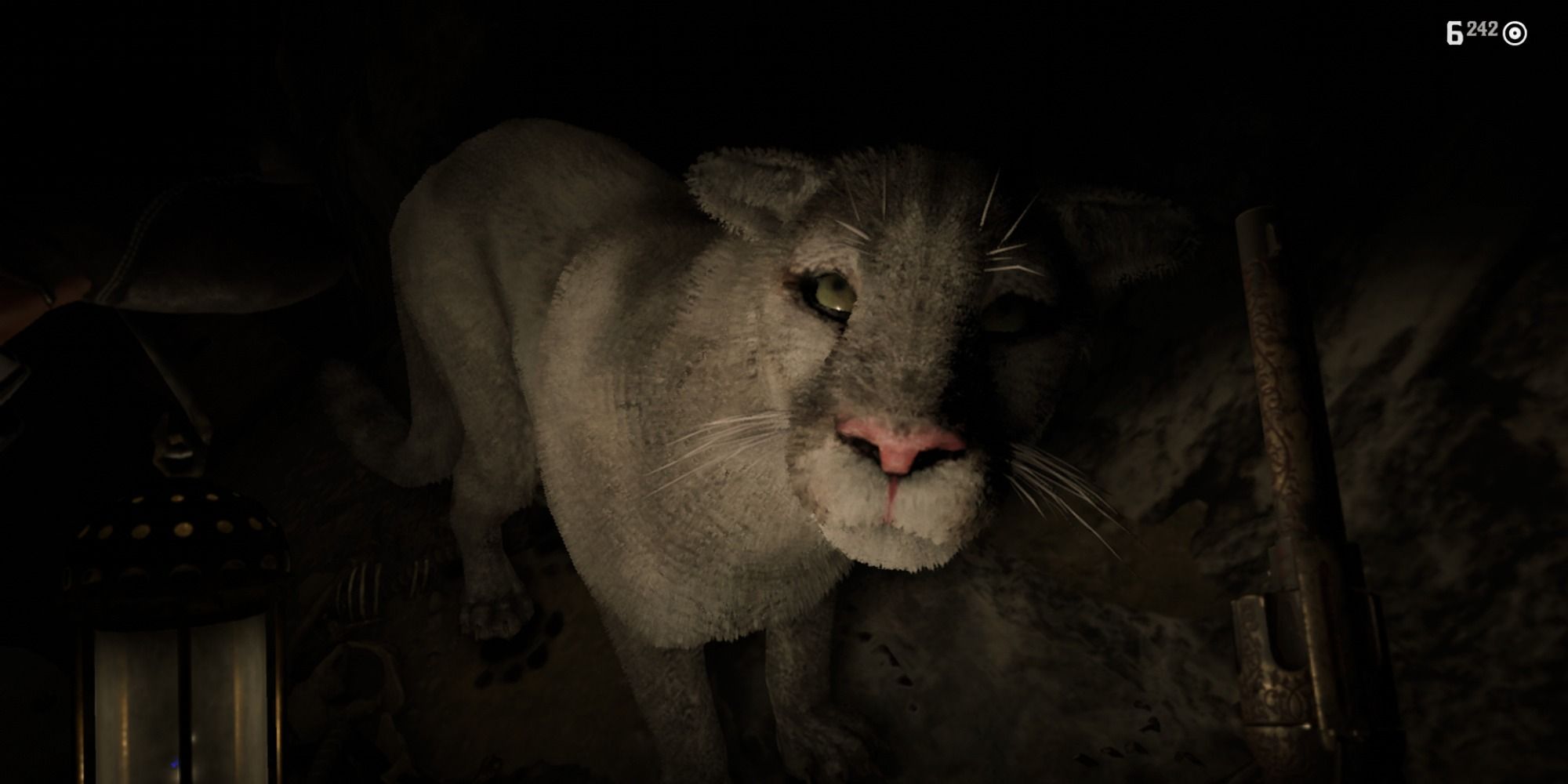 An image of a Cougar from Red Dead Redemption 2 living in a cave. This large cat has gray fur. 