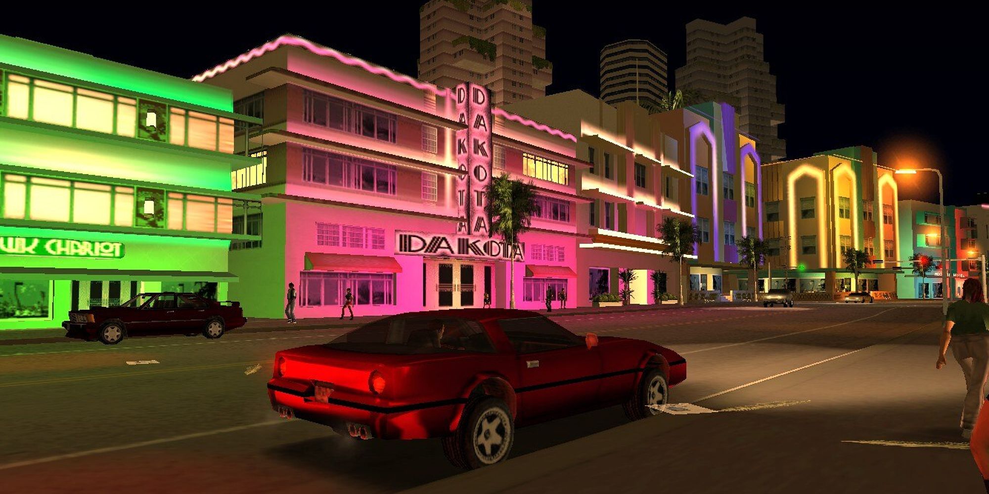 A red sports car seated at the street of neon buildings