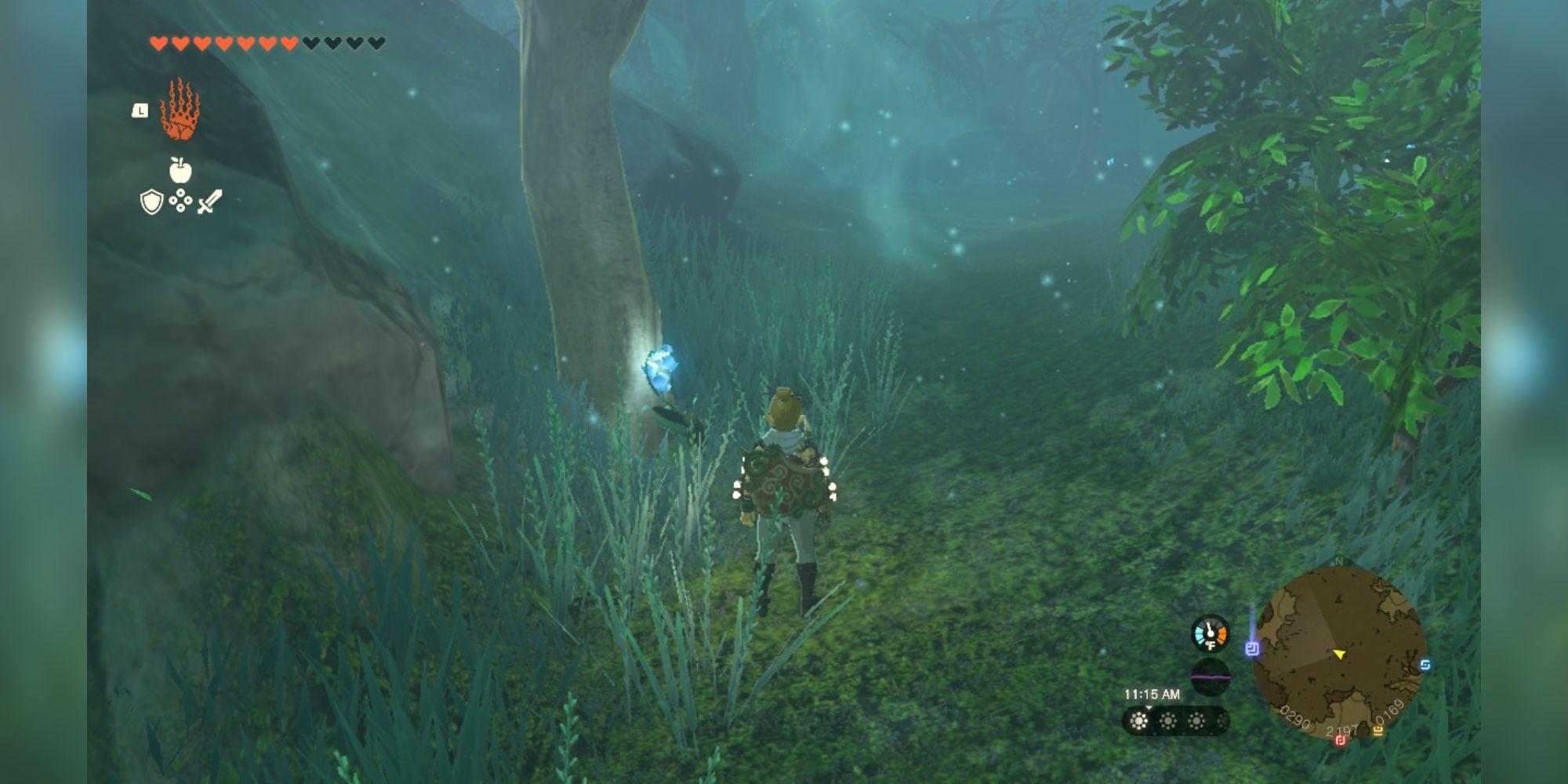 Link stands in a misty forest looking at a glowing blue flower.