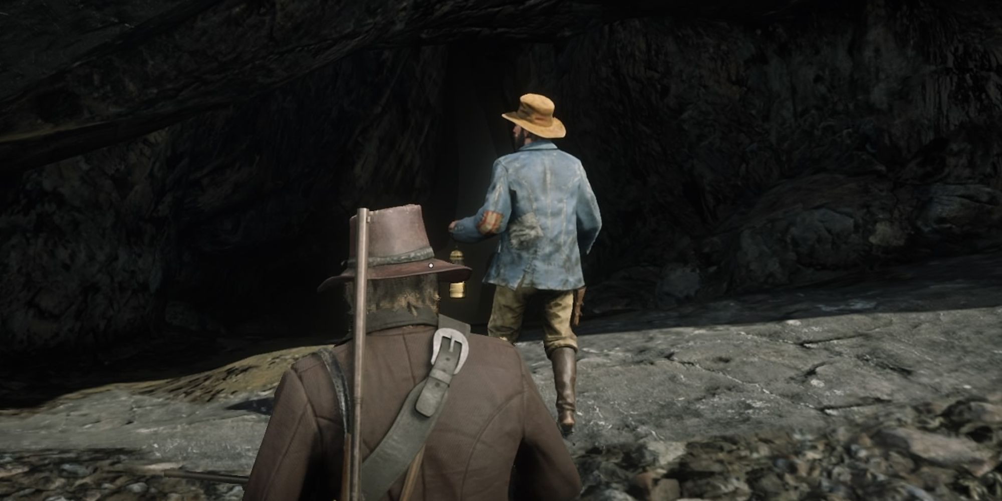 Red Dead Redemption 2 Screenshot Of Arthur And Winton Holmes Walking Into Cave