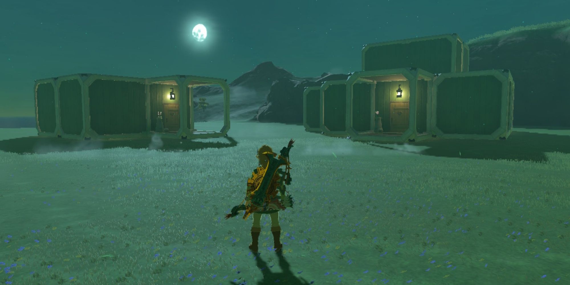 Tears of the Kingdom - Link standing outside of his dream house and a guest house with the moon in the background