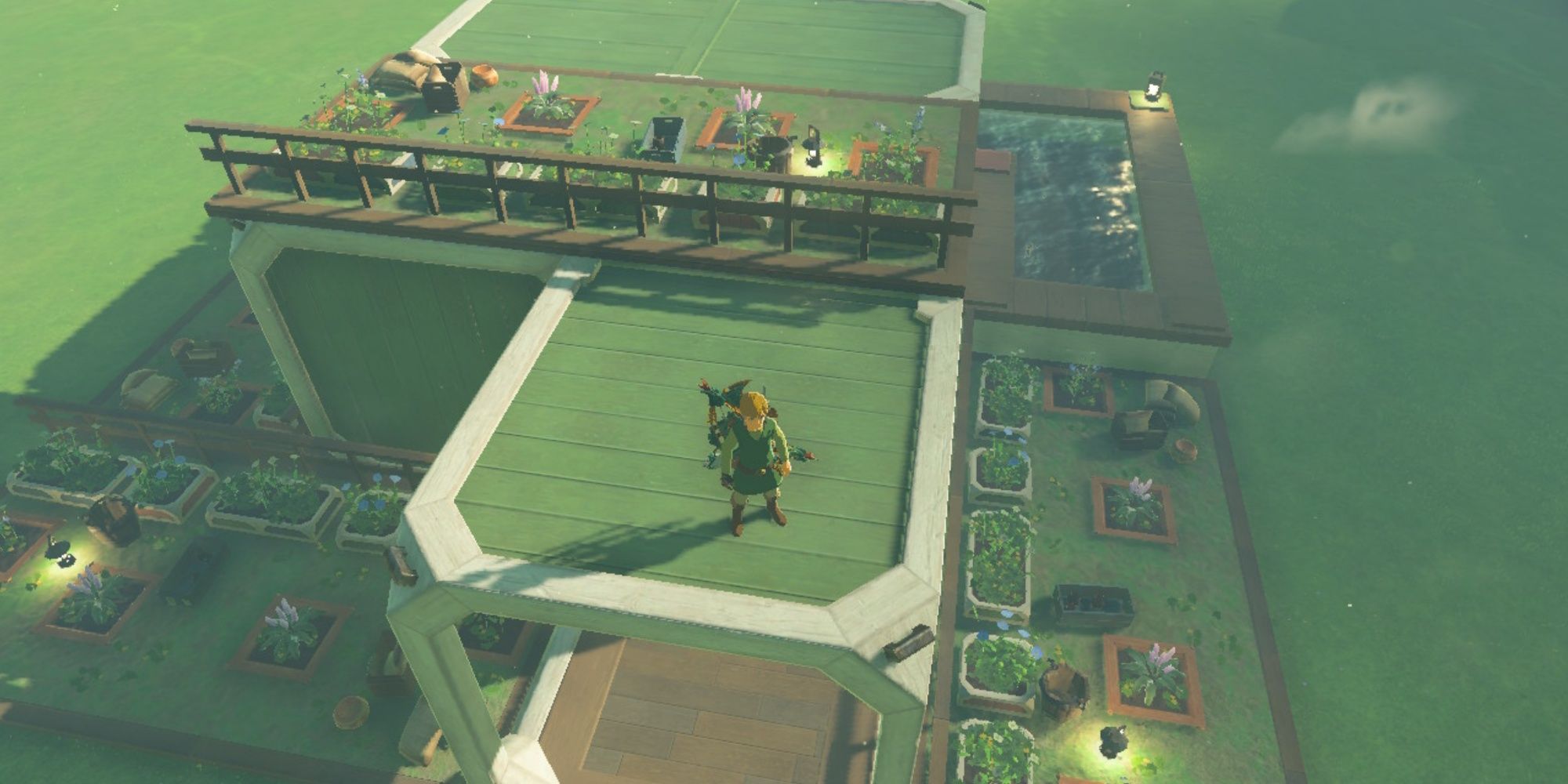 Tears of the kingdom - top down view of Link on his house's roof, with roof garden, gardens surrounding the house, and a pond