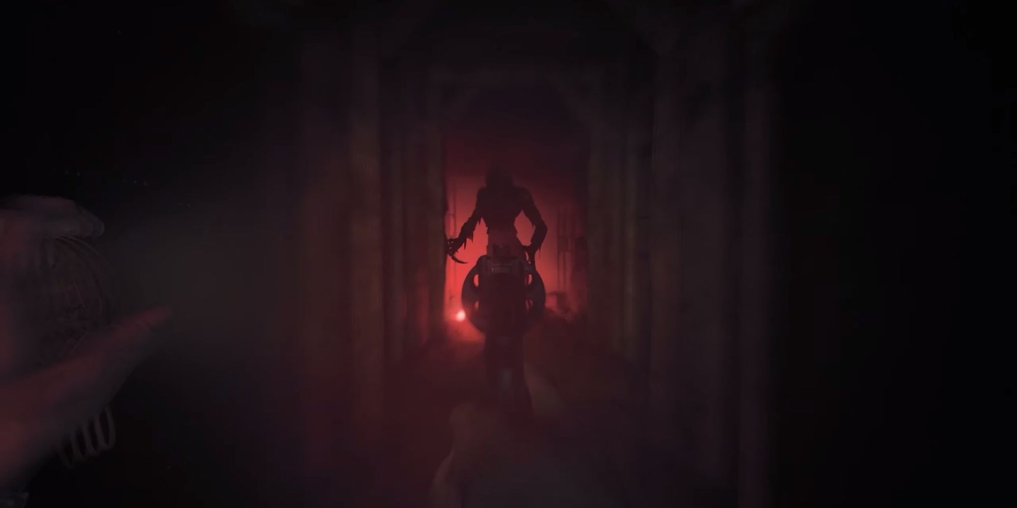 Henri aiming gun at the beast with a red glow in the background in Amnesia: The Bunker