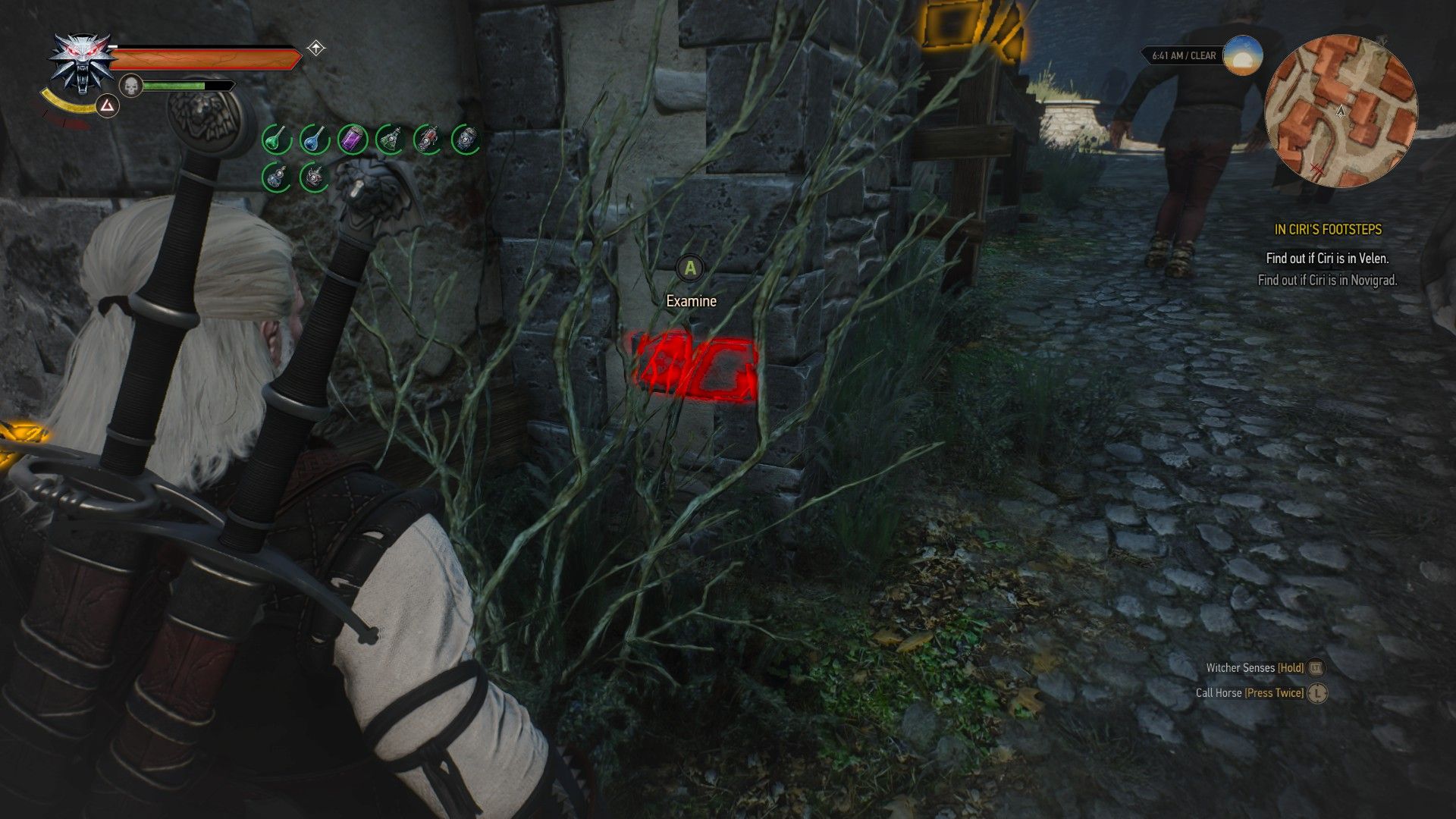 A screenshot of Geralt looking at a brick in Novigrad.