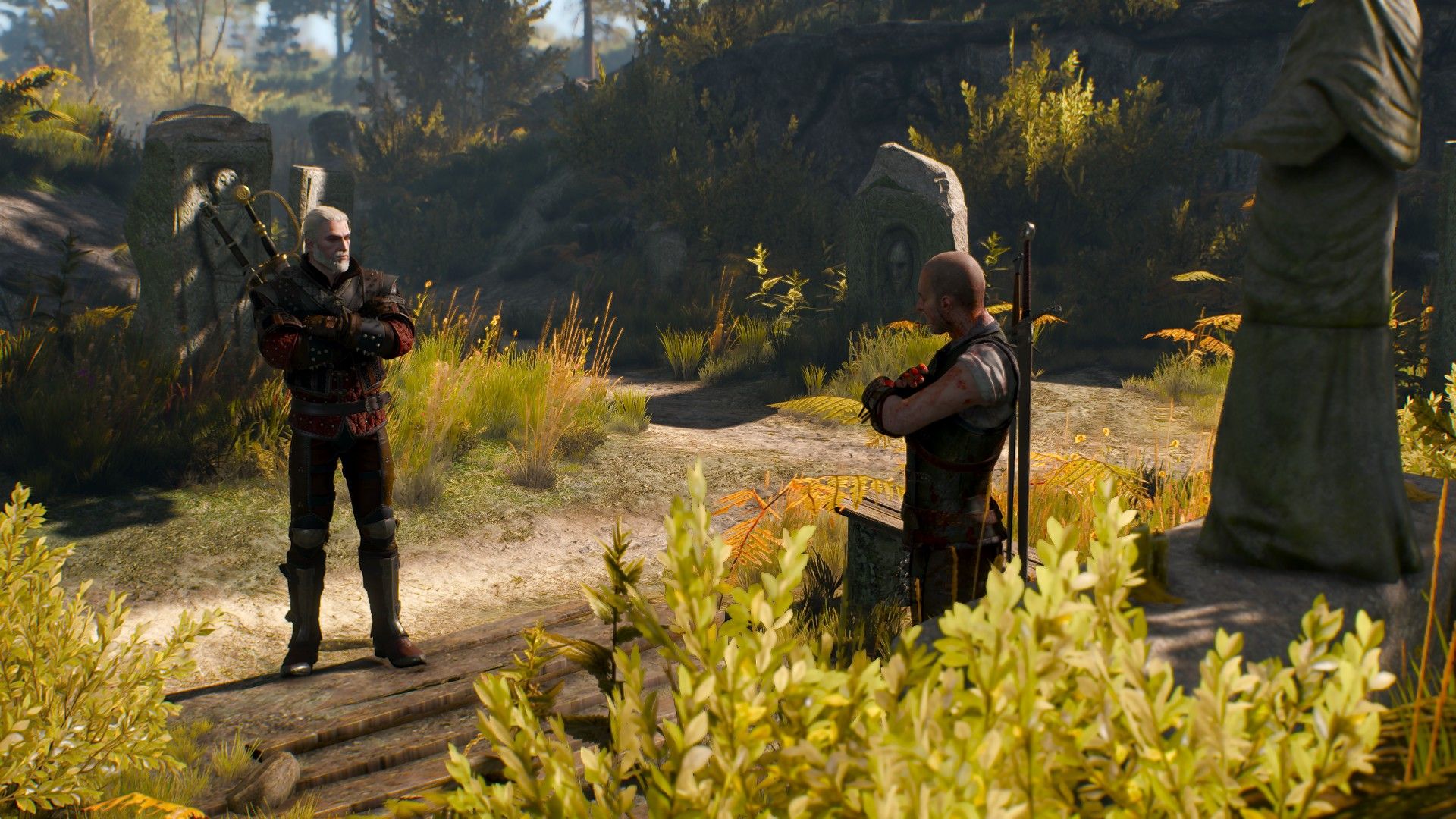 Geralt and Gaetan glare at each other with their arms crossed as they talk in the woods.