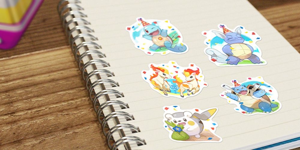 Five different Pokemon Go 7th Anniversary Stickers on the page of a notepad