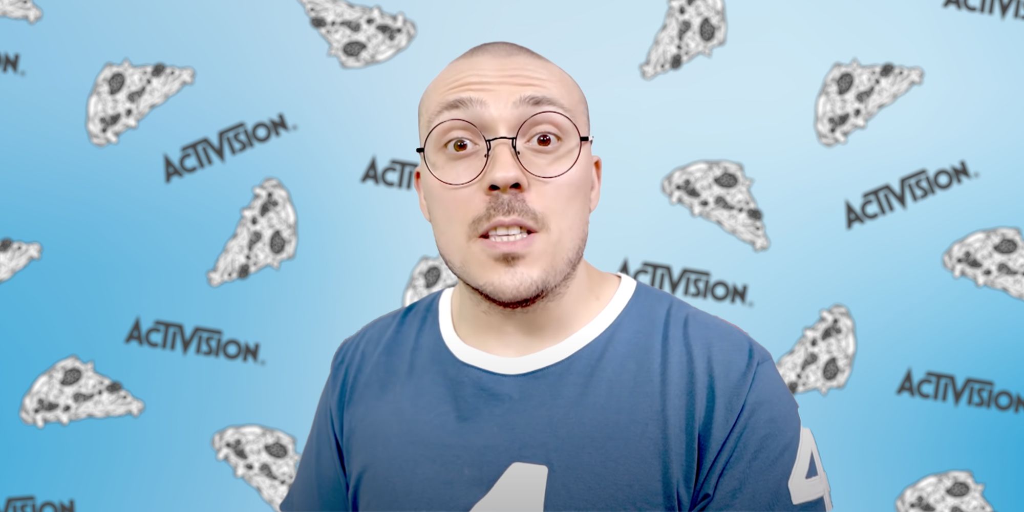 Anthony Fantano in front of a blue gradient with art of pizza and several Activision logos