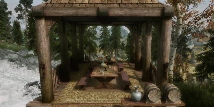 an-outdoor-room-with-tables-benches-teapots-teacups-candles-barrels-a-jug-surrounded-by-trees.jpg (740×370)