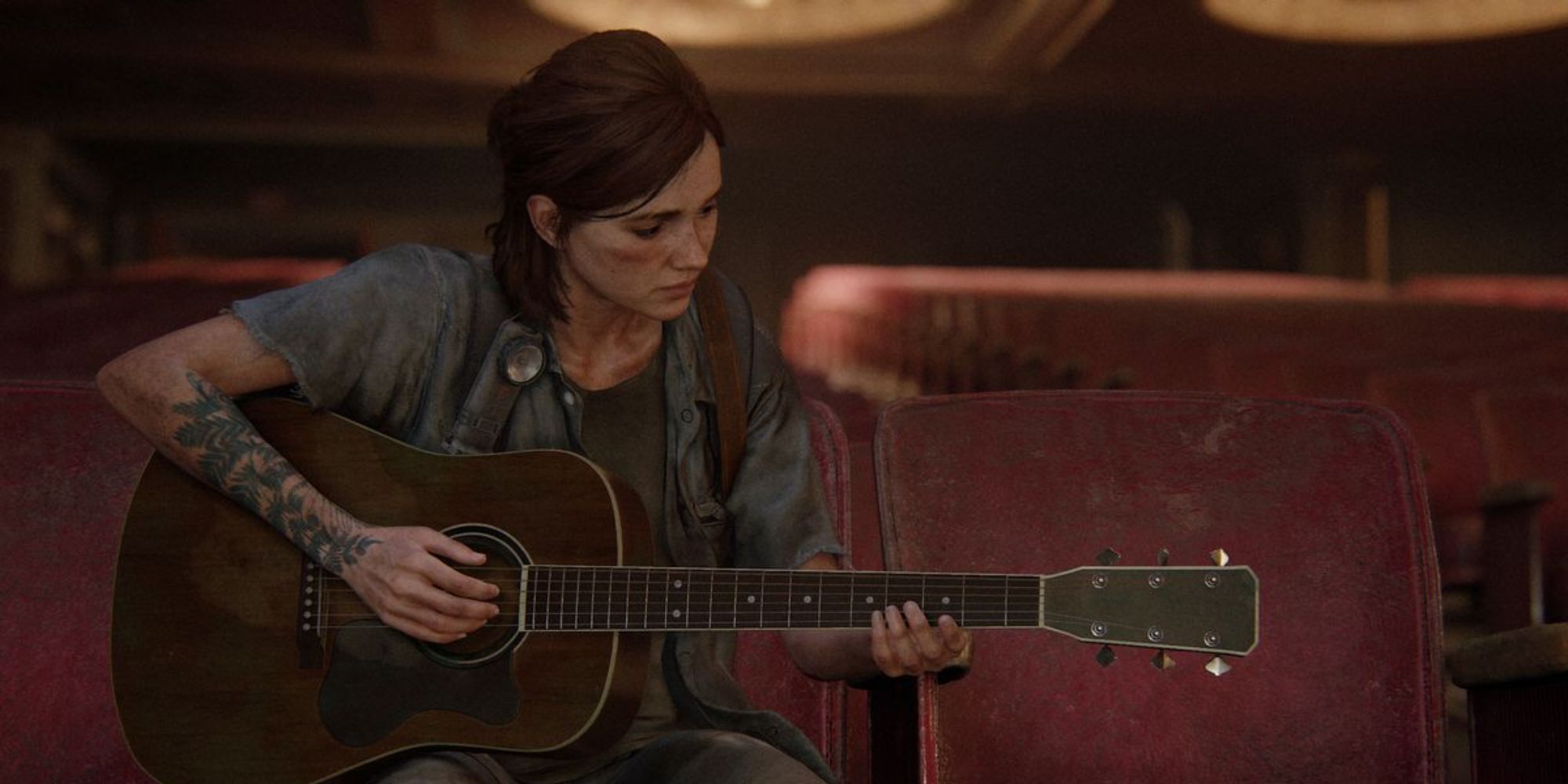Ellie playing the guitar in The Last of Us Part 2.
