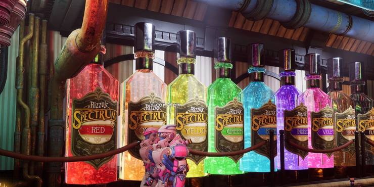 A variety of brightly colored and glowing drinks in gigantic bottles against a wall.