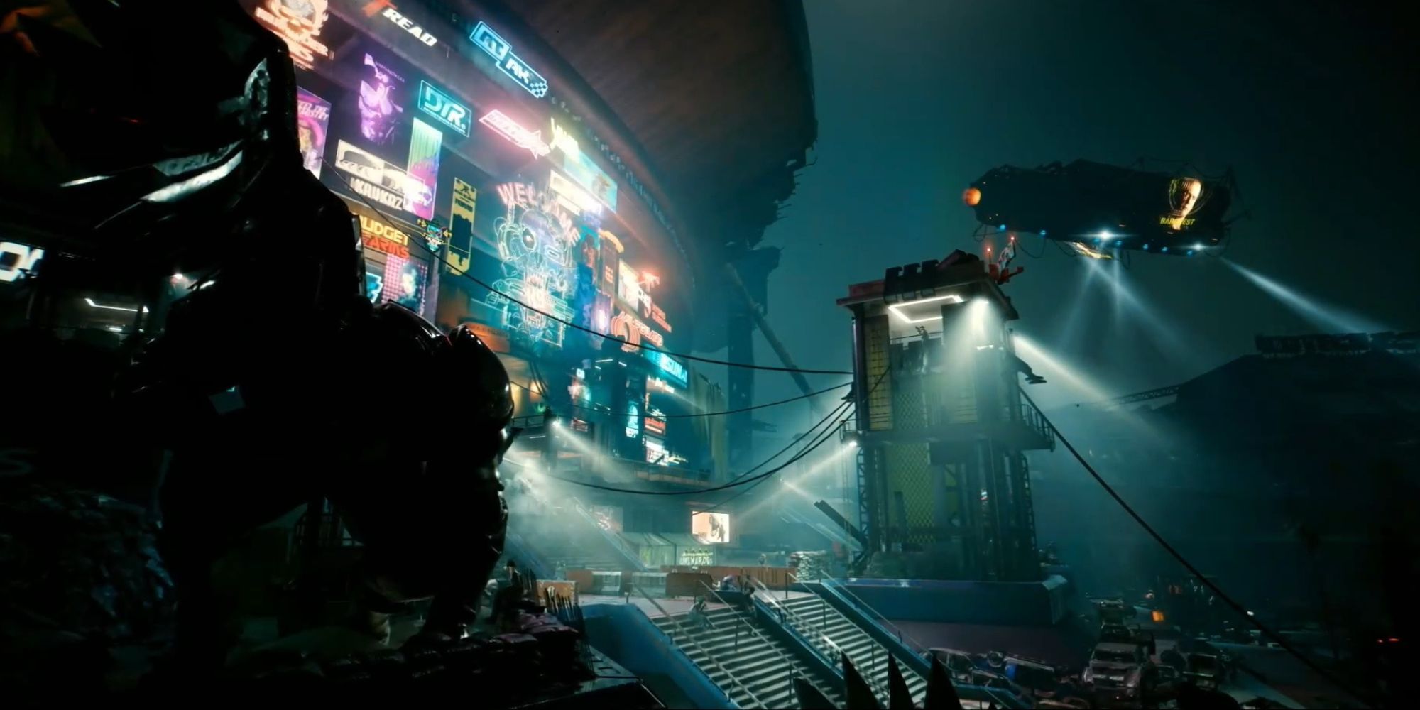 A screenshot from Cyberpunk 2077. It shows a futuristic city setting with bright neon lights. 