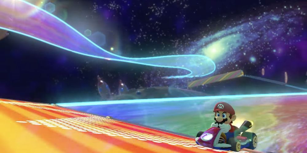 Mario speeding through the Rainbow Road circuit