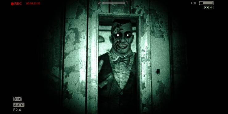 Outlast nightvision shot of asylum patient smiling