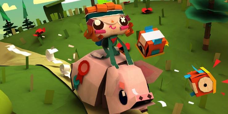 Iota riding a paper pig in a green field. 