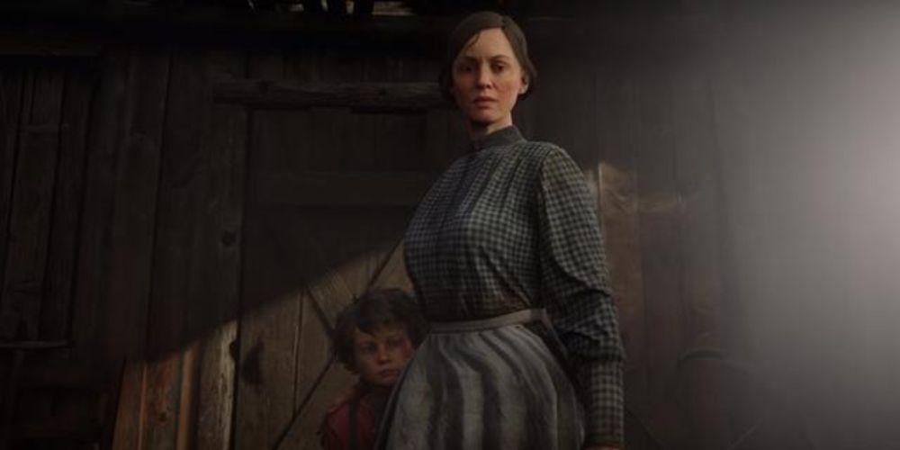 Red Dead Redemption 2 Screenshot Of Mrs Londonderry Looking Straight Ahead With Her Kid Behind Her