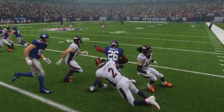 Saquon Barkley evading tackle on the side