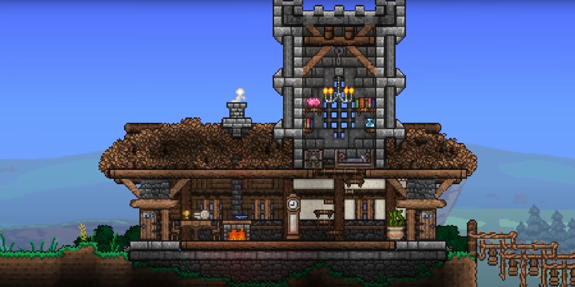 An image from Terraria of a Medieval house. This build is equipped with a stone tower and gothic decorations that make the build appear from a different time period.