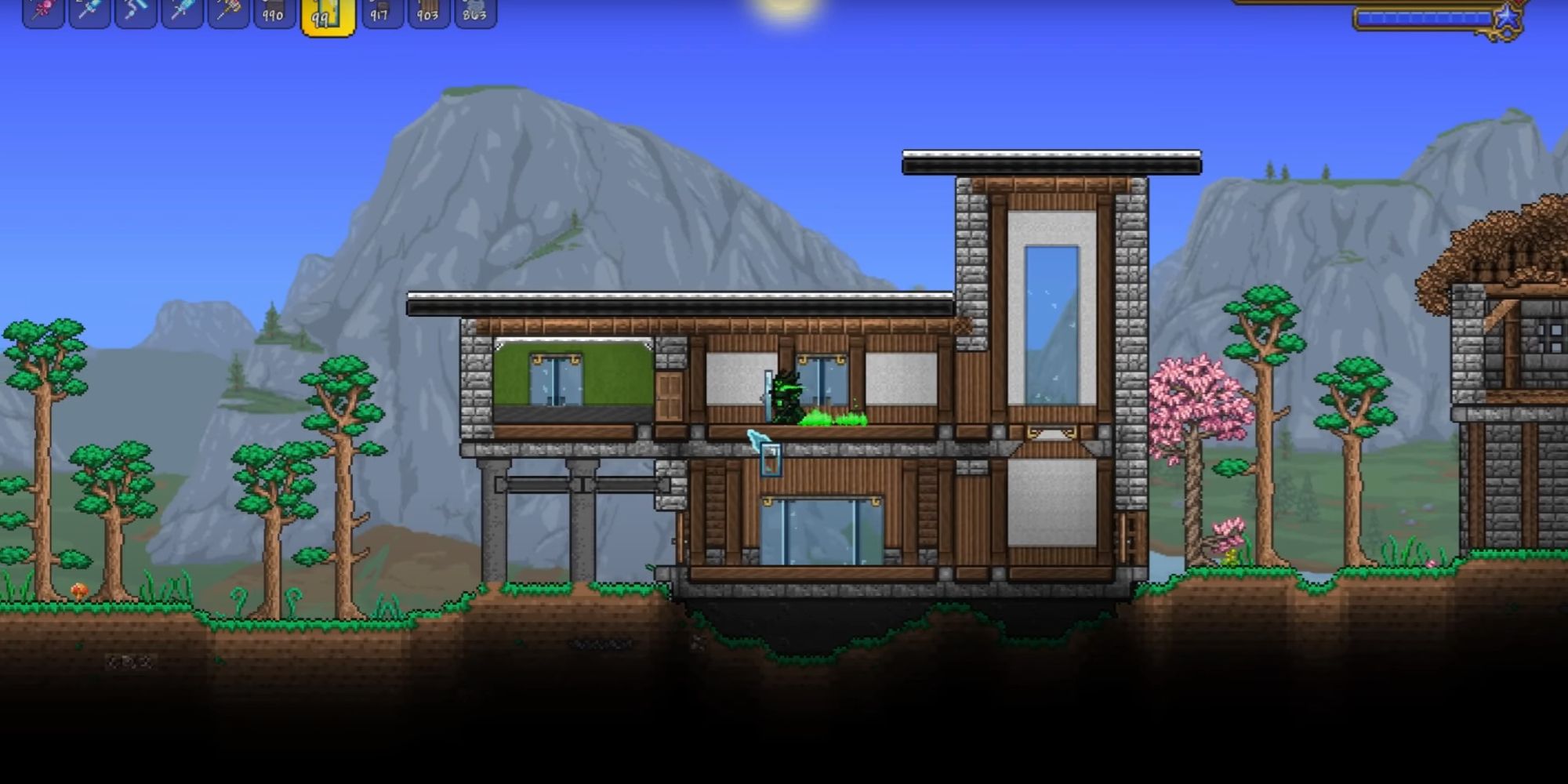 An image from Terraria of a house with a modern design. This build features a flat roof made out of stone, to give the structure a contemporary aesthetic.