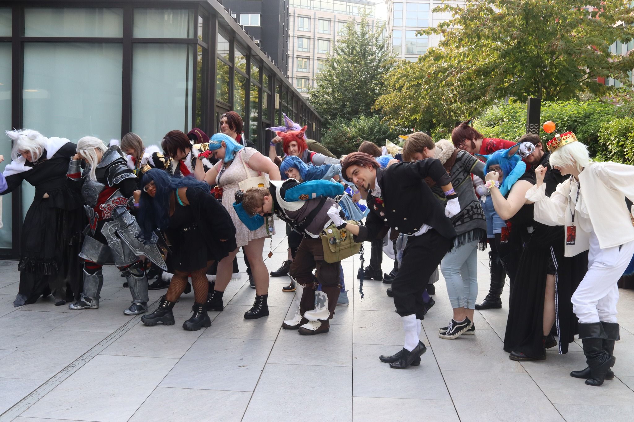 A bunch of Final Fantasy 14 cosplayers performing the manderville pose.
