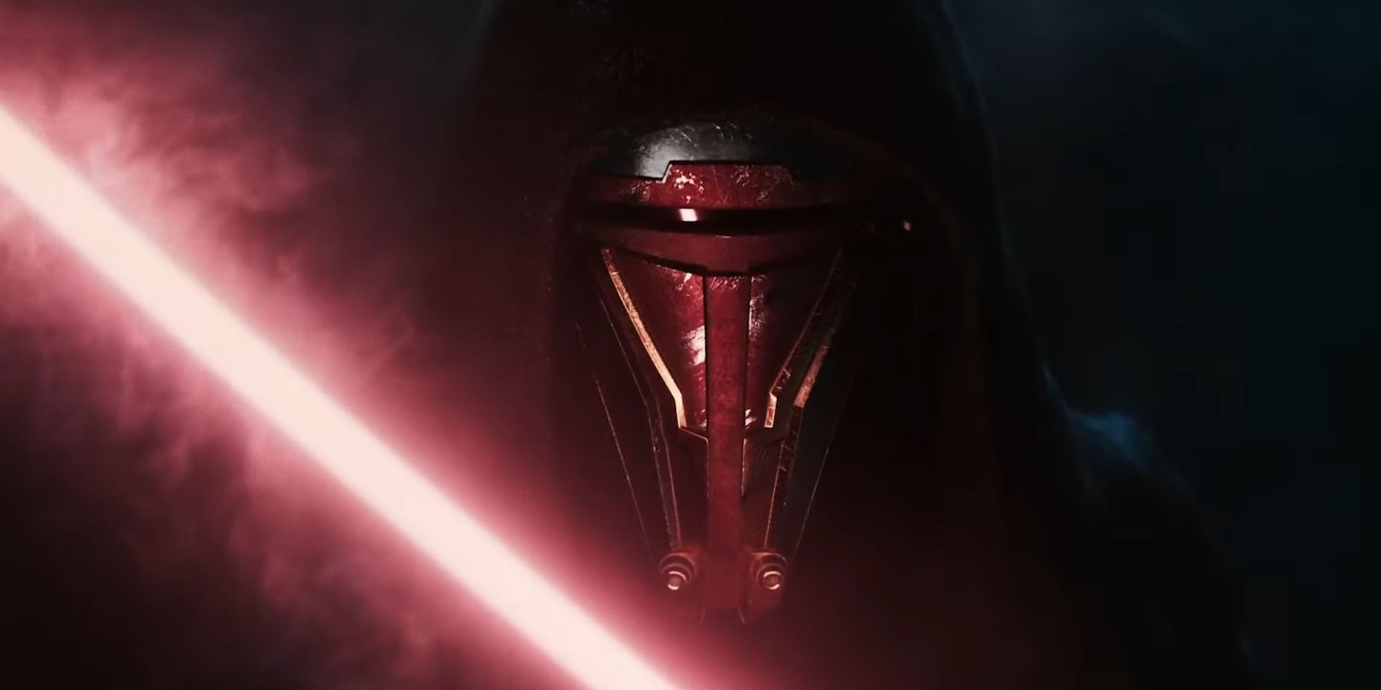 A close up of Darth Revan in pitch black darkness illuminated by the glow of a red lightsaber