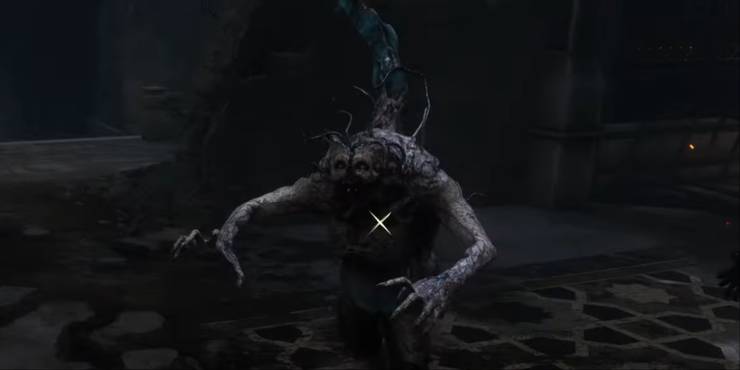 A close-up of a hunchback zombie-like enemy from Lies of P with a blue stinger sticking out from the back.