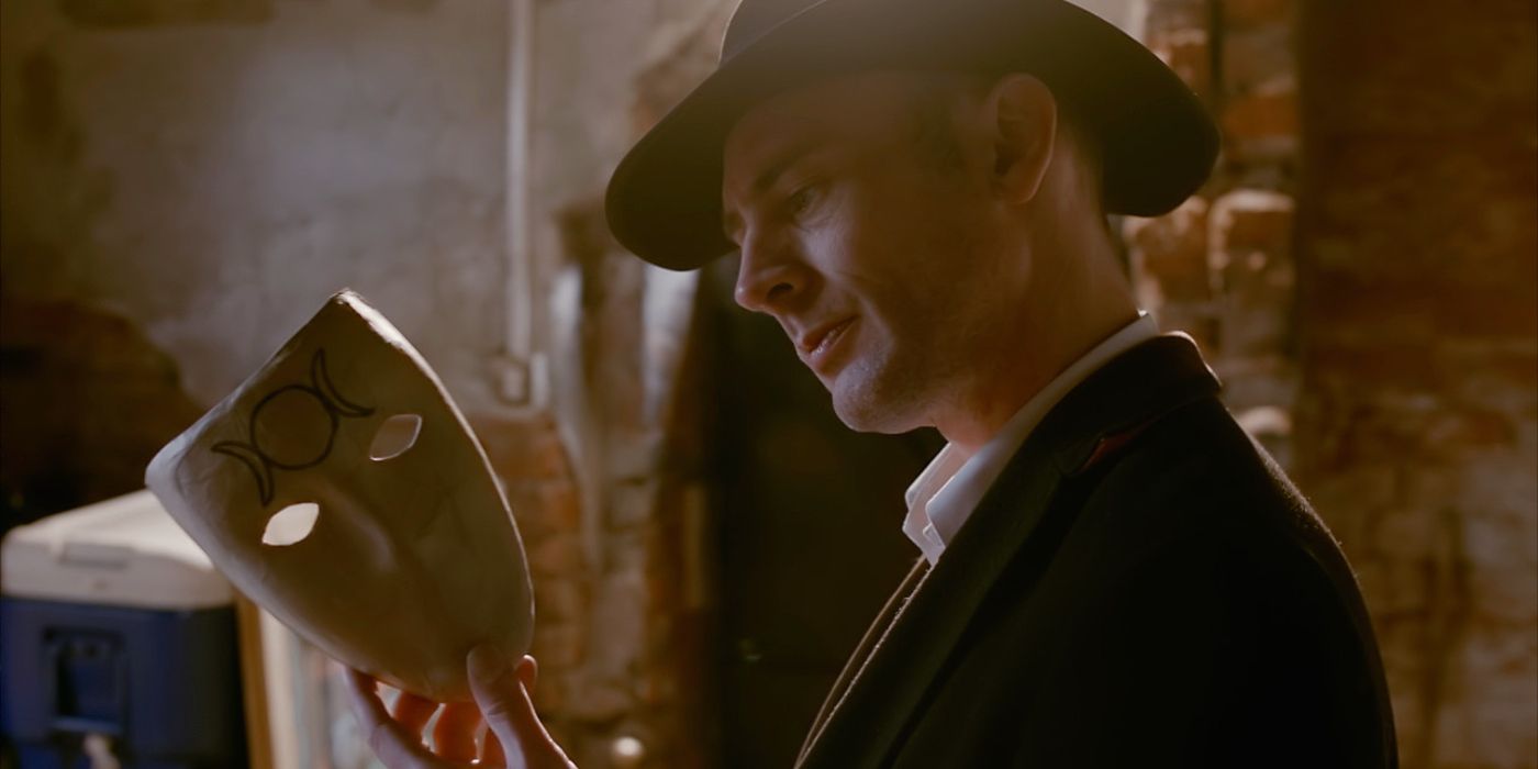 Detective Frederick Jenks played by Rupert Booth Holding A Mask