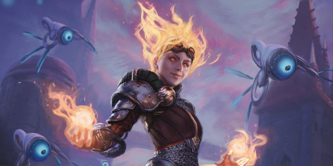 Chandra stands tall with flames in both her hands and hair. Clad in metal and leather armour, she stands in front of several flying thopters