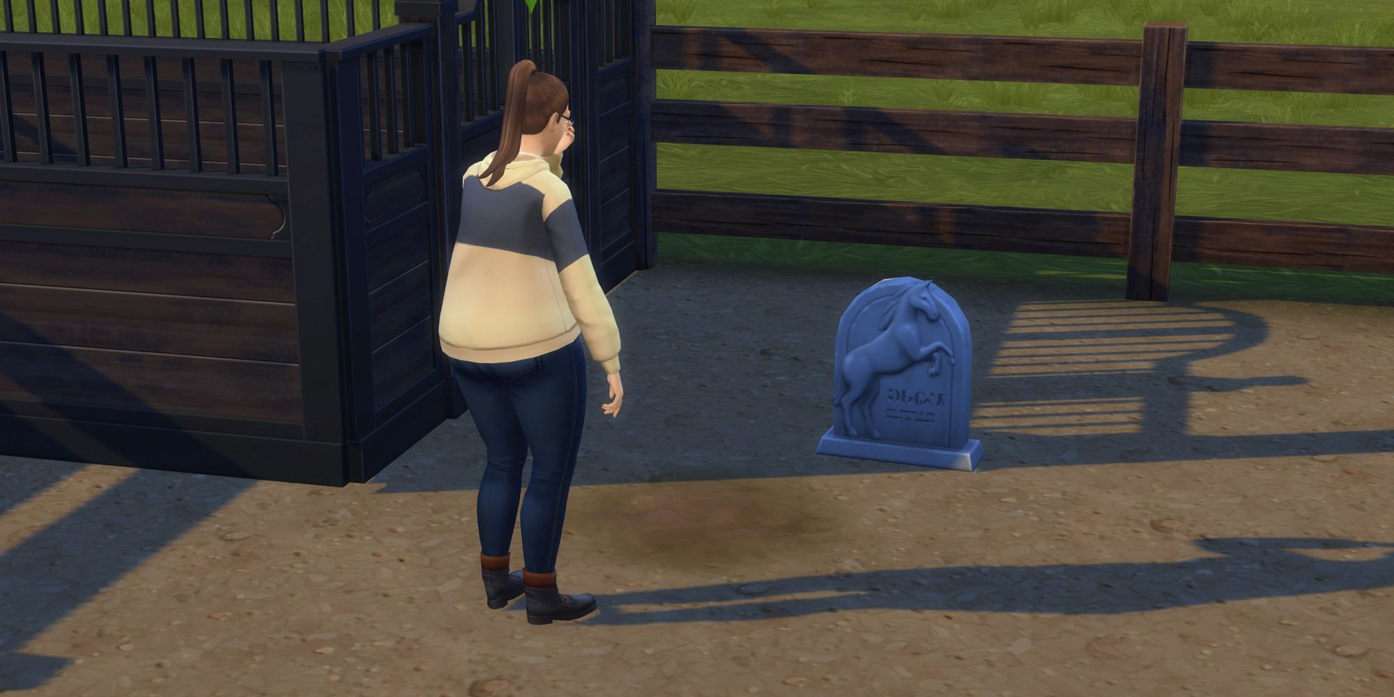 A sim mourning a horse at a tombstone