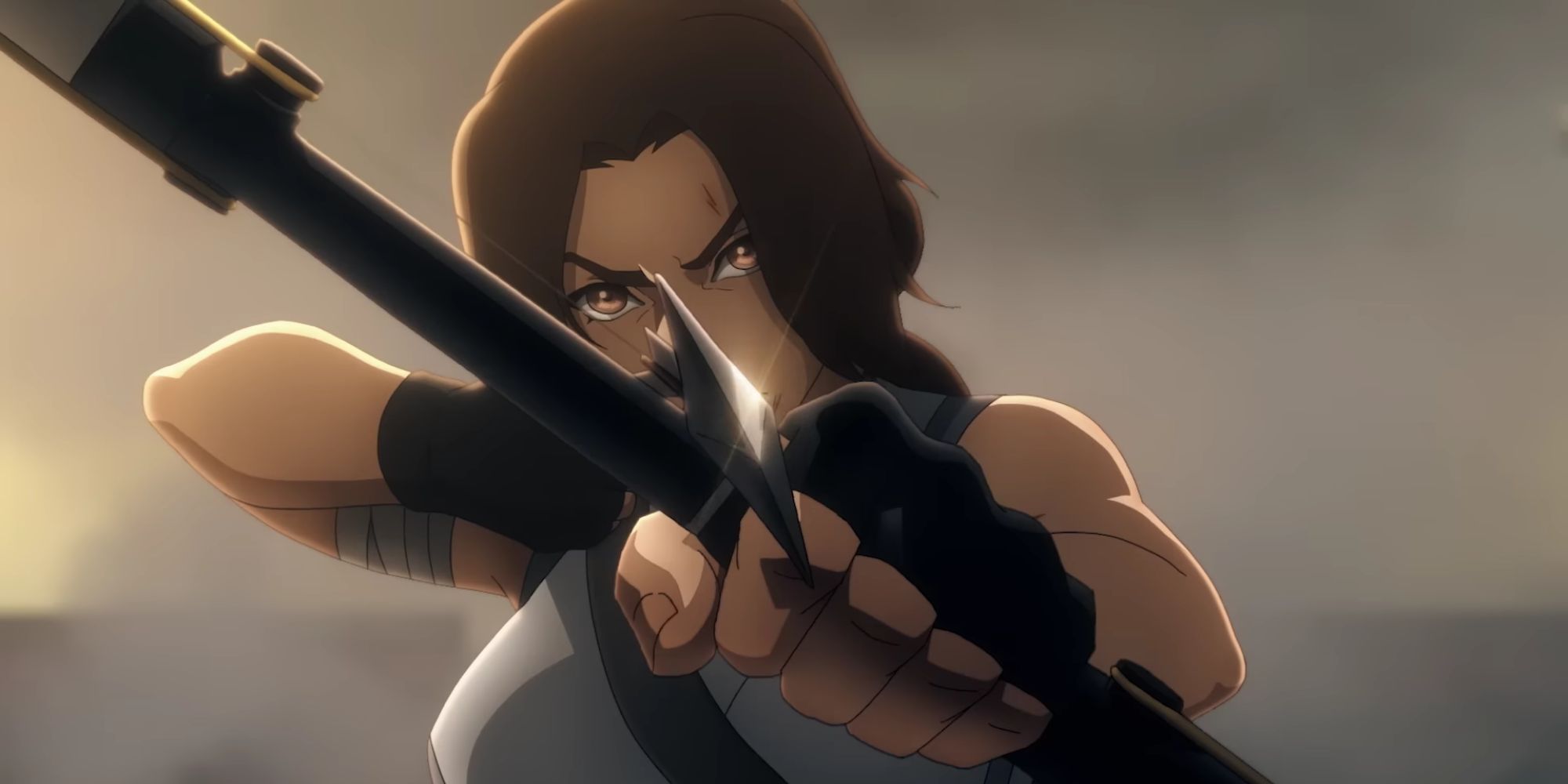 Lara Croft pointing a bow and arrow at the camera in the Tomb Raider anime.