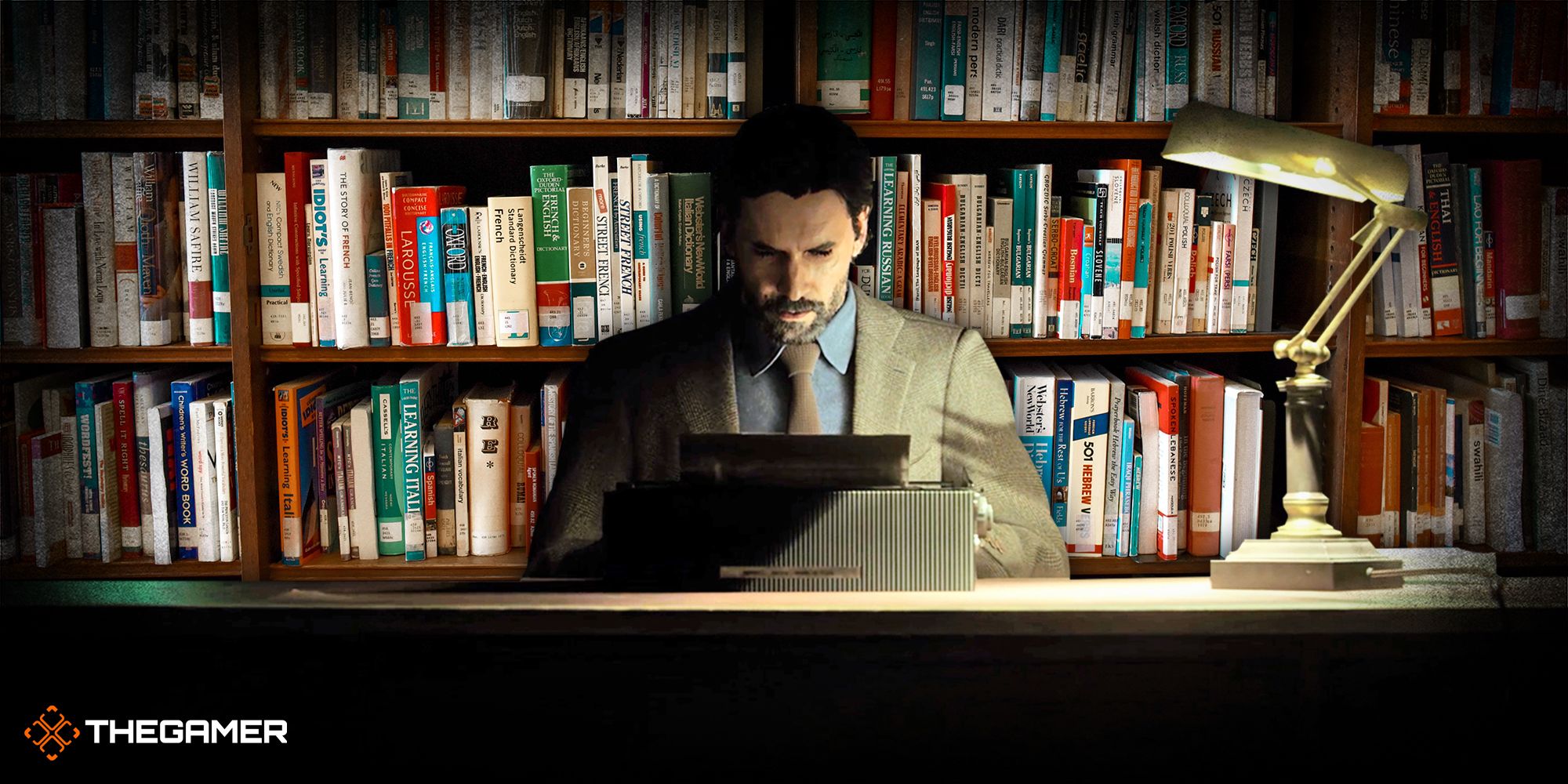 Alan Wake from Alan Wake 2 sitting at his desk reading something with a desk lamp to his left. There s a bookshelf full of books behind him.
