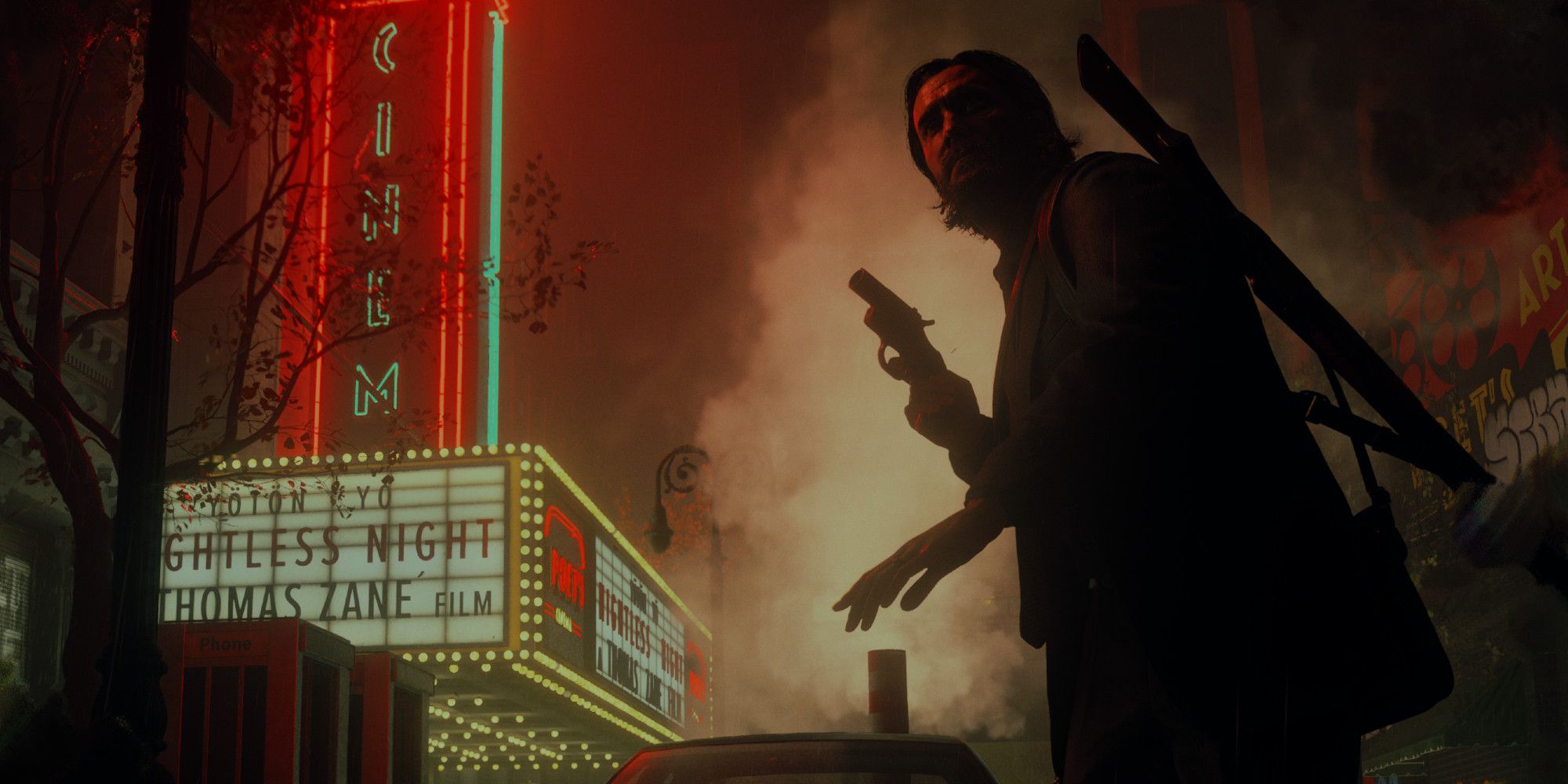 Alan Wake in a dark New York street lit up by the glow of a nearby theatre sign in the background