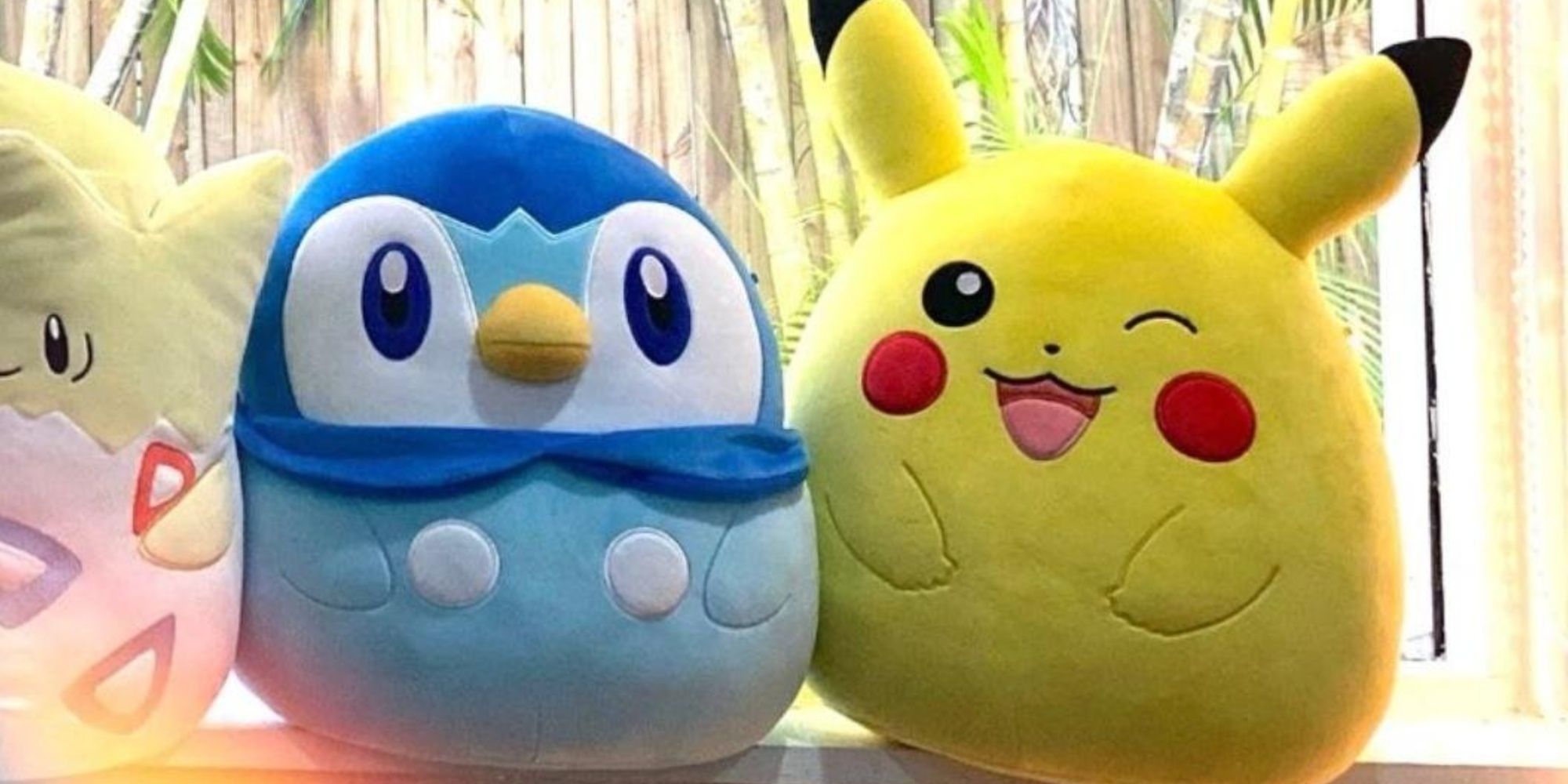 piplup and wining pikachu squishmallows on a window sill
