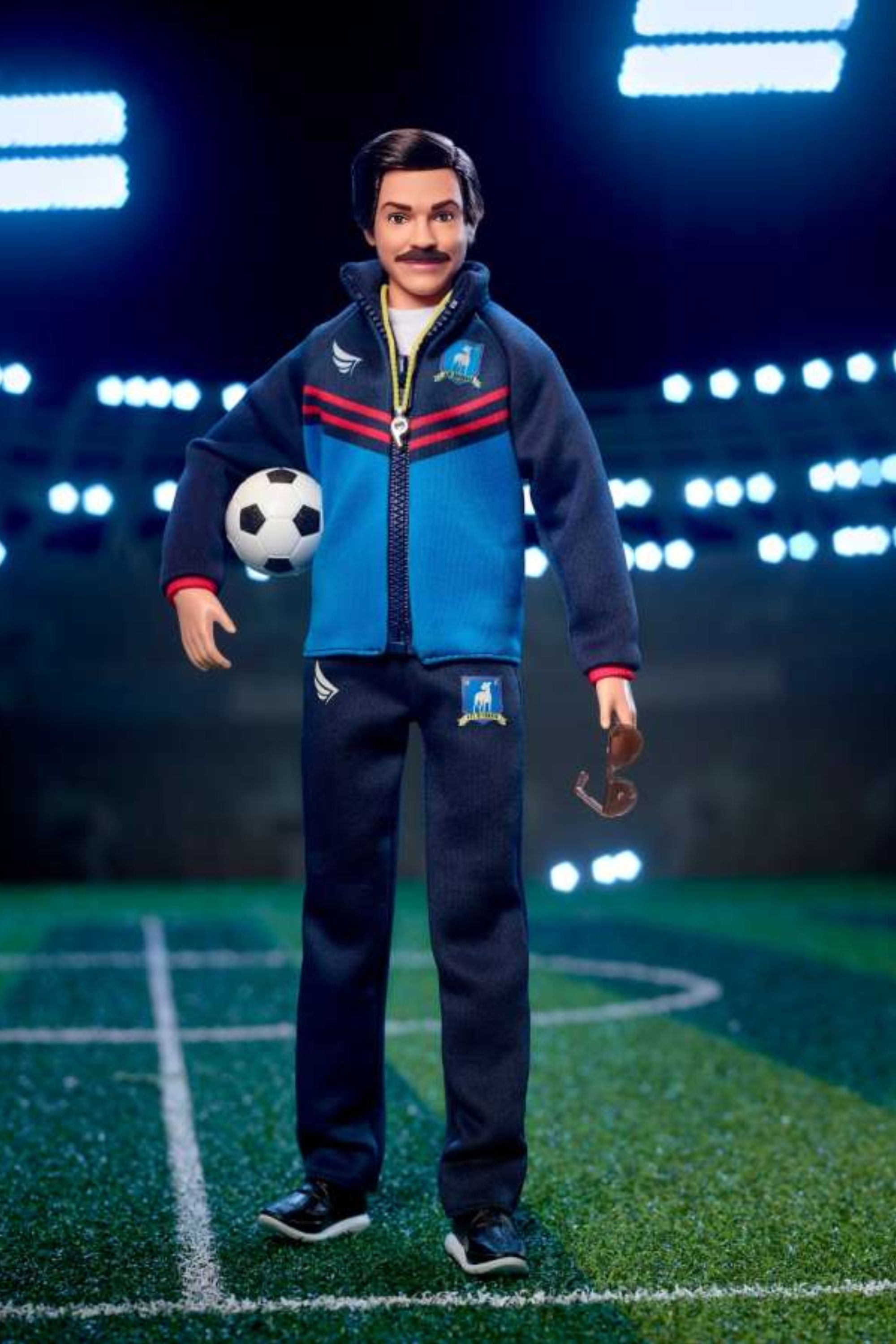 Barbie Signature Ted Lasso Collectible Doll holding a football