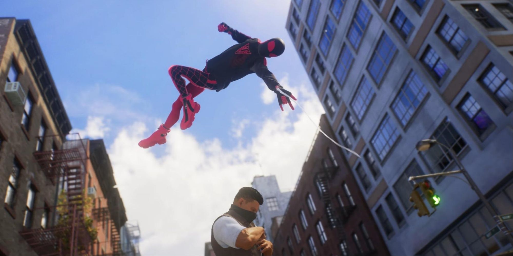 Miles Morales in his 10th Anniversary Suit above a criminal, ready to strike.