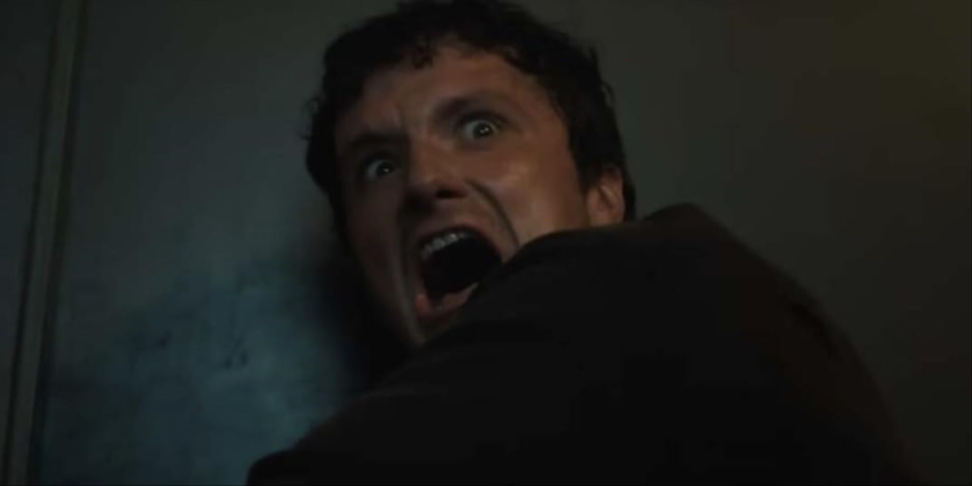 Josh Hutcherson on the ground screaming and horrified at something he's seeing in the FNAF movie.