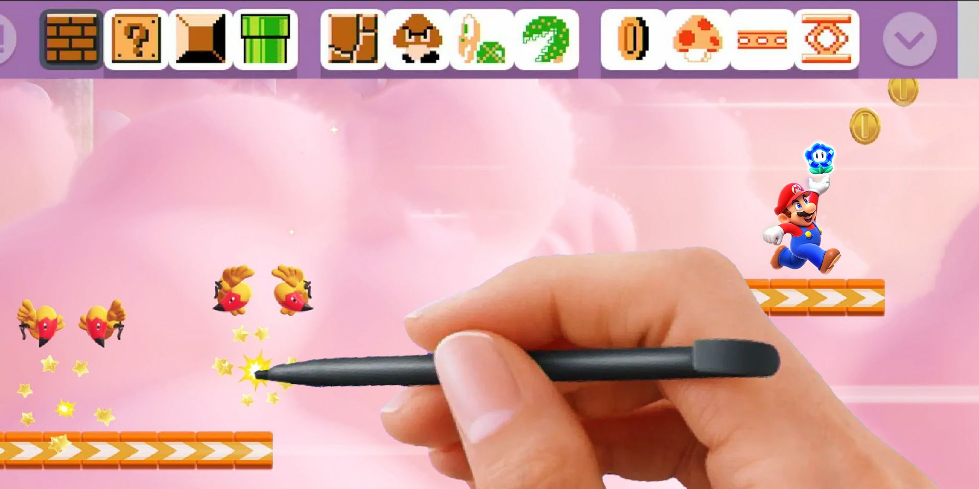 Super Mario Bros. Wonder gameplay with the Super Mario Maker HUD and a player's hand and stylus overlaid on top of it.