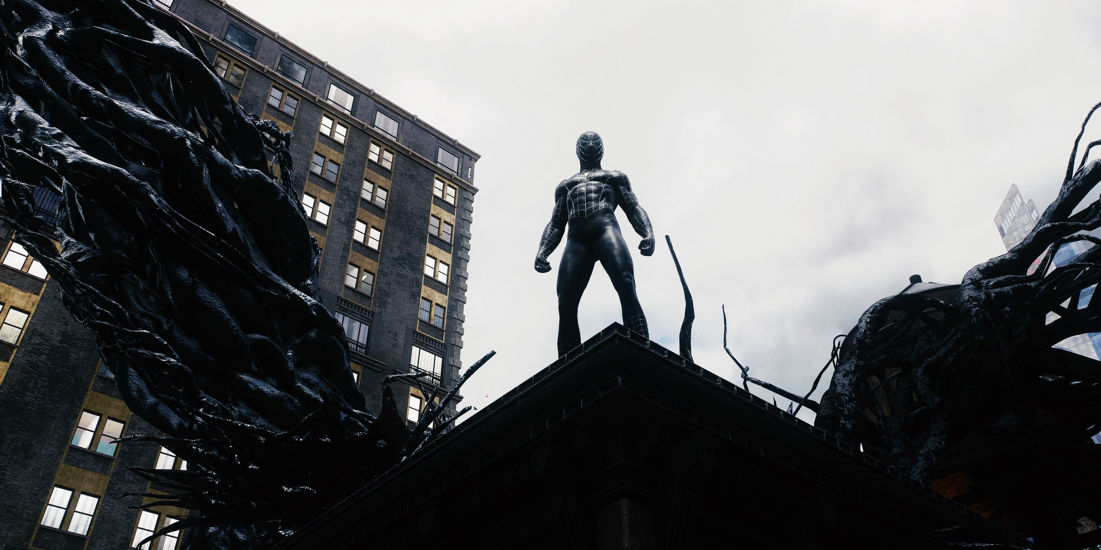 Marvel's Spider-Man 2 Peter dressed in black standing above a city Symbiote nest surrounded by tendrils