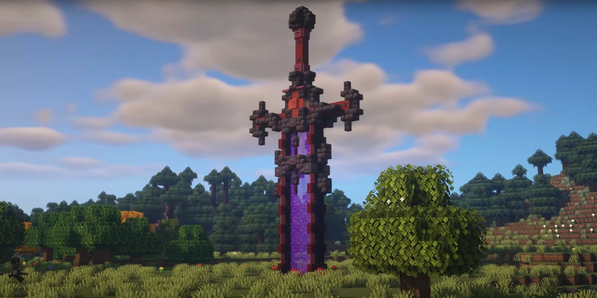 An image from Minecraft of a giant Nether Portal, which is combined with blakcstone to make the portal look like a massive sword thrust into the ground.