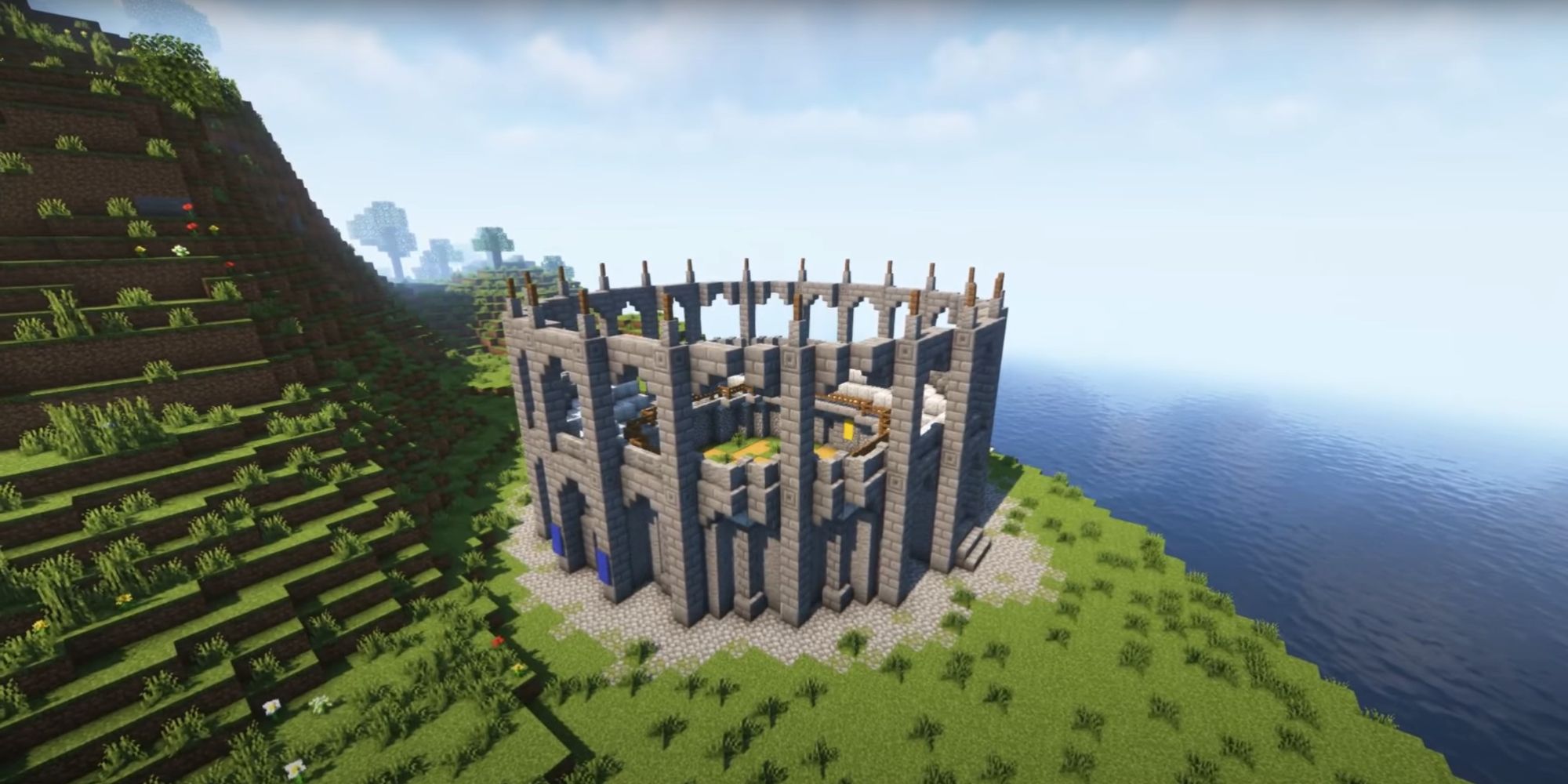An image from Minecraft of a small arena on the side of a cliff, overlooking the ocean.