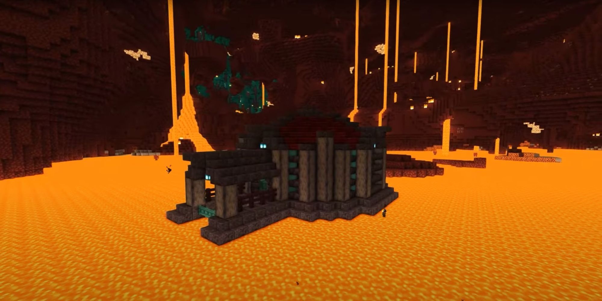 An image from Minecraft of a Small Nether Base, which is built on a lava lake and has a pen to hold striders.