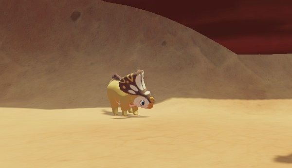 Yellow and brown Protoceratops standing near a rock wall in Ariacotta Canyon during the day in Paleo Pines.